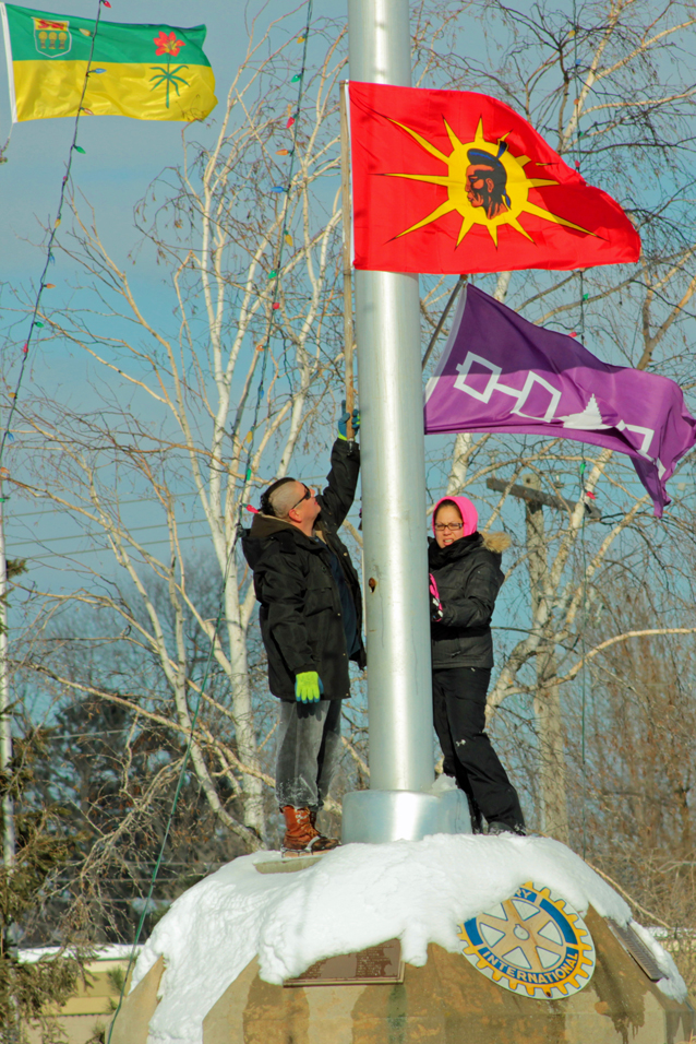 Protestors planting indigenous flags below Canadian flag